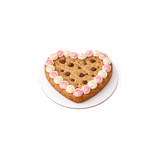 Heart-shaped cookie cake with chocolate chips and pink frosting on a white background.